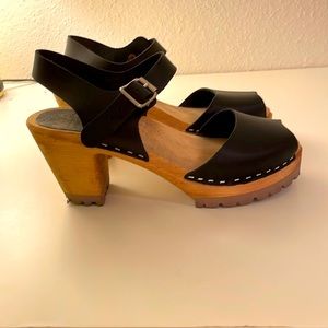 Black MIA Swedish clogs. Peep toe; 3'' heel. Size 7.